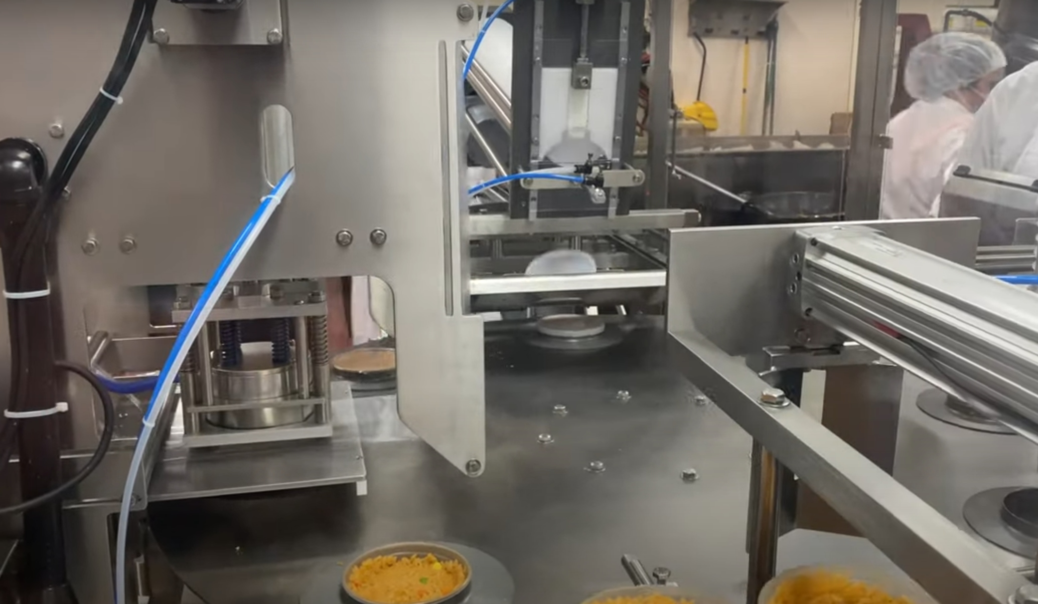 RM48 packaging machine, auto load tray sealer, pre-filled cup sealing machine, rice cup packaging, Rocket Machine Works RM48, large dial plate packaging machine, versatile sealing equipment, cup capping machine, industrial food packaging, flexible filling and sealing