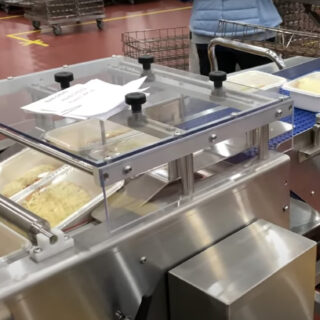 Our Square Cut Tray Sealer is built for institutional meal prep, sealing four trays at a time in facilities like schools and correctional institutions. This 30-foot machine ensures high output, consistent sealing, and smooth integration with accumulation tables for bulk packaging needs.