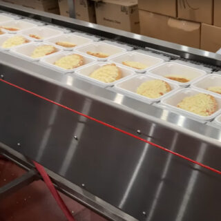 Our Square Cut Tray Sealer is built for institutional meal prep, sealing four trays at a time in facilities like schools and correctional institutions. This 30-foot machine ensures high output, consistent sealing, and smooth integration with accumulation tables for bulk packaging needs.