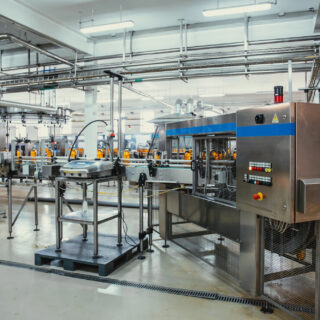 2026 Food Packaging Trends: How Custom Machinery Can Future-Proof Your Operations: Plastic bottles with juice on automated conveyor line or belt in modern beverage plant or factory production